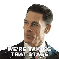 a man in a suit and tie is saying " we 're taking that stage "
