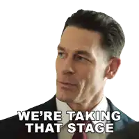 a man in a suit and tie is saying " we 're taking that stage "