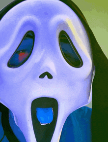 a person wearing a scream mask with their tongue sticking out