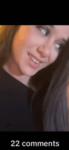 a close up of a woman 's face with 22 comments on it