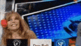 a woman is sitting at a desk with a sign that says don roll