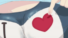 a person is pointing at a heart on a shirt that says i love