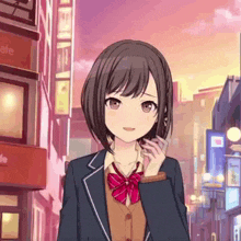 a girl in a school uniform is standing on a city street .