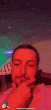 a man with a beard is giving a thumbs up in front of a colorful background