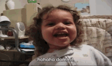 a little girl is laughing with the words " hahaha dammit " above her