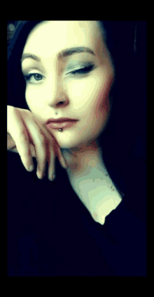 a woman with a nose ring and a lip ring