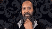 a man wearing headphones is making a funny face .