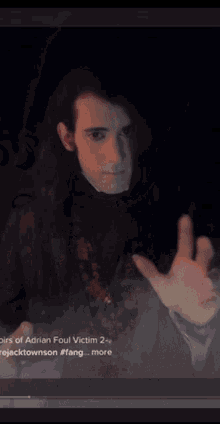 a blurred image of a person with the name adrian foul on the bottom right