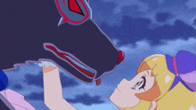 a girl in a purple and yellow outfit is looking at a black dog
