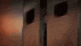 a man in a black shirt is standing in front of a burning building