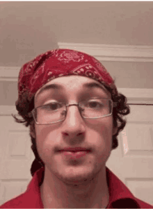 a young man wearing glasses and a red bandana on his head