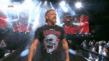 a man with a beard wearing a black t-shirt with a skull on it is walking into a ring .