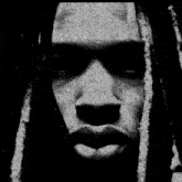a black and white photo of a man 's face with red eyes