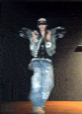 a blurry picture of a person dancing with a hat that says ' a ' on it