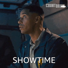 a man in a blue jacket with the word showtime on the bottom right
