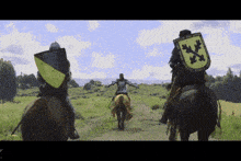 a man riding a horse with a yellow and black shield