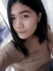 a close up of a woman taking a selfie with a blurred background .