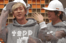 a person wearing a hoodie that says topp
