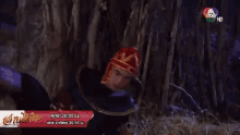 a man in a costume is laying in a cave with a sign that says 7 hd on it