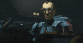 a cartoon character wearing goggles is sitting in a dark room