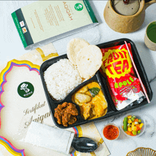 a tray of food with a certificate that says walida on it