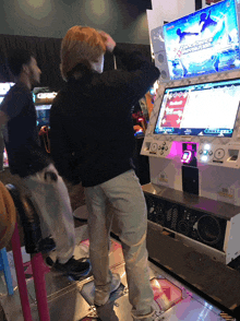 a man playing a video game with a screen that says dance dance dance