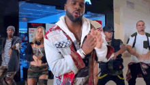 a group of people dancing in front of a beauty parlor sign