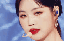 a close up of a woman 's face wearing a microphone
