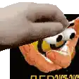a close up of a person holding a stuffed animal with a face on it .