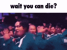 a group of people are standing in a line with the words wait you can die below them