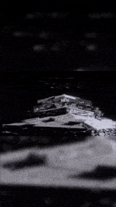 a black and white photo of a star destroyer with the words star wars on the bottom