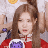 a girl wearing a red jacket has a sticker on her neck that says juum