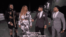 a group of men and a woman are standing next to each other and talking
