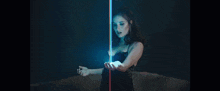 a woman is holding a light in her hands .