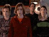 a group of people stand in front of a sign that says " hell wanted "