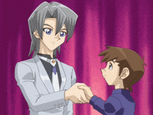a man and a boy shake hands in front of a purple curtain