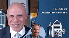 a bald man in a suit and tie is smiling in front of a blue background .