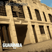 a poster for the la guarimba international film festival with a building in the background