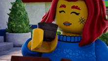a lego woman with red hair is drinking a cup of coffee