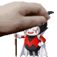 a cartoon character in a red and black outfit is holding a cane while a hand holds a blanket over him .