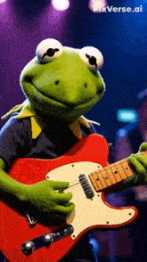 kermit the frog is playing a red electric guitar on a stage