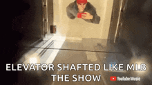 a man is taking a picture of himself in an elevator with the caption elevator shafted like mlb the show .