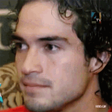 a close up of a man 's face with rbd.gif written below it