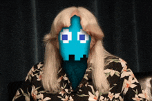 a woman in a floral shirt has a blue pixelated face on her face