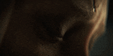 a close up of a person 's face with a tear coming out of it