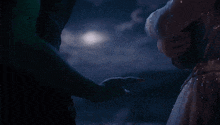 a woman in a white dress holds a man 's hand