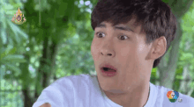a man in a white shirt is making a surprised face