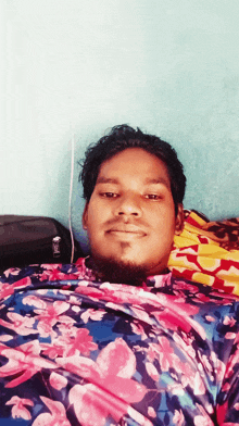 a man with a beard wearing a floral shirt