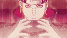 a close up of a person 's face with a pink background and a red headband .