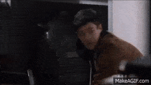 a man in a brown jacket is fighting another man